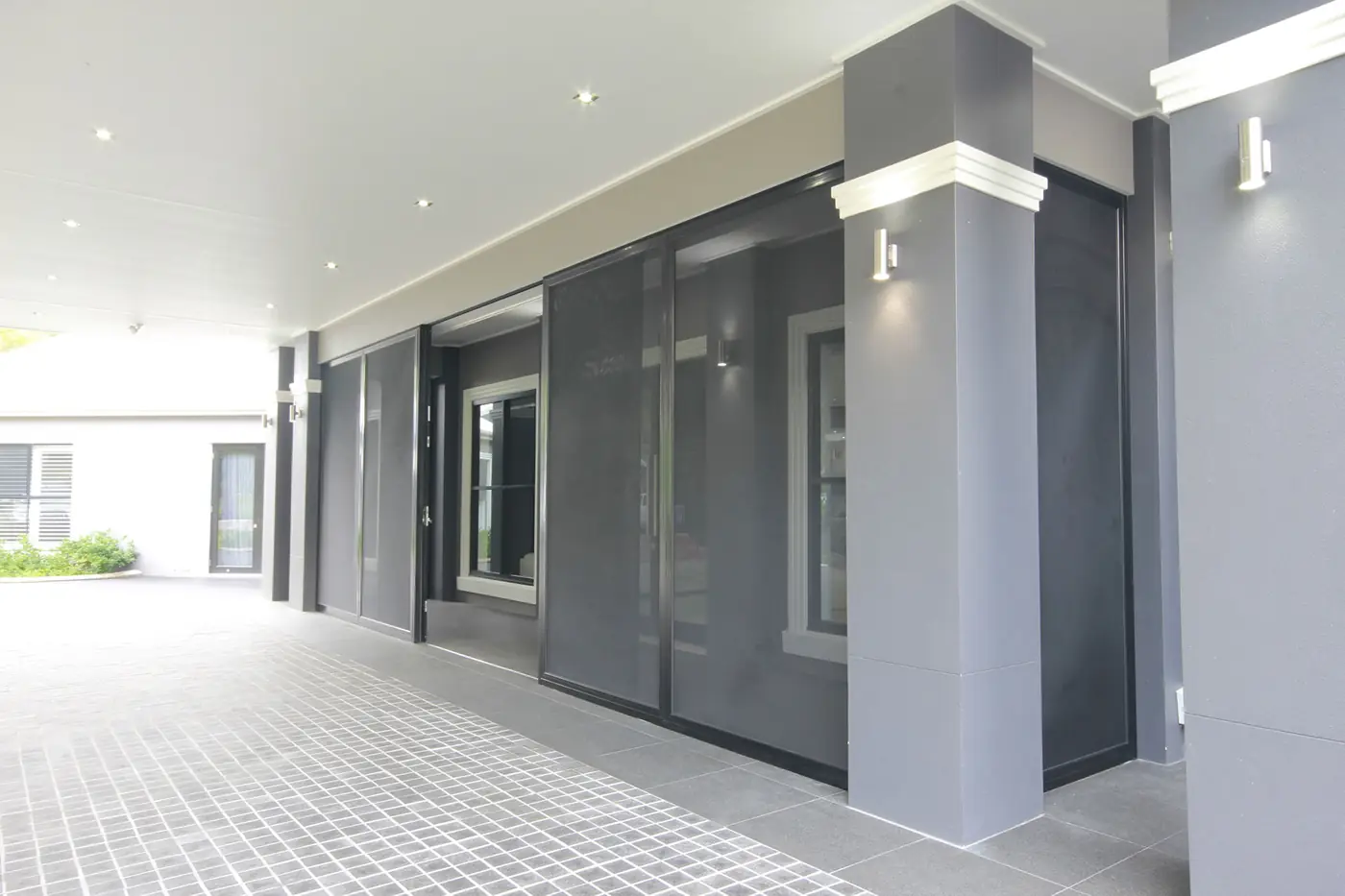 Crimsafe sliding screens along a covered walkway at the side of a Brisbane home
